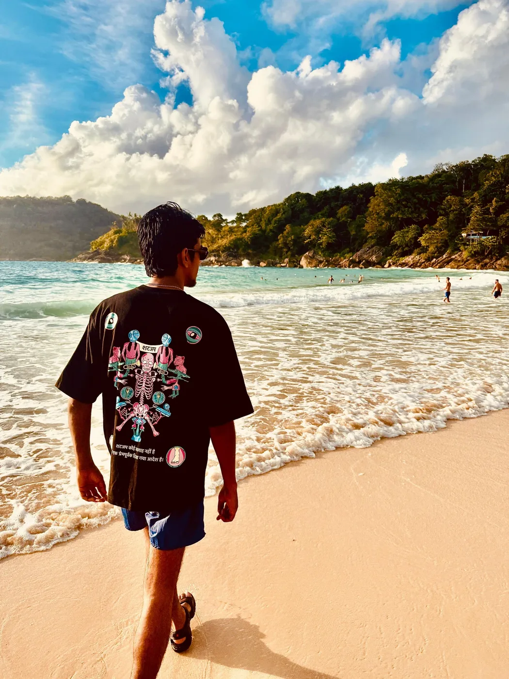 Rebel wearing the SHUTUP tee at the beach