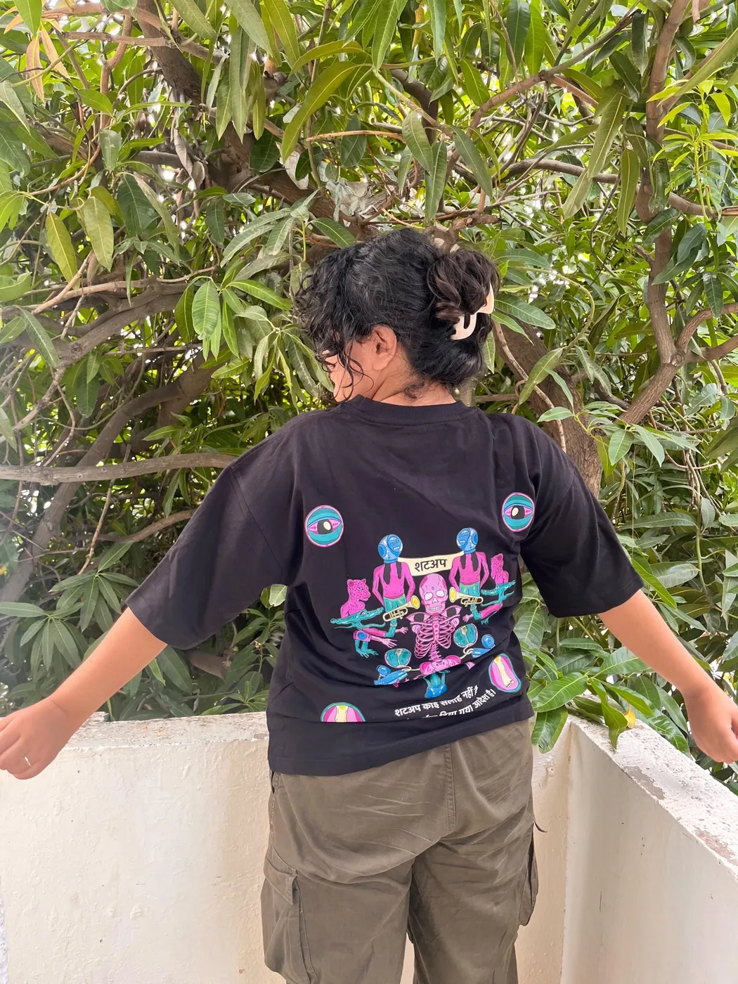 Rebel showing the back artwork against a tree